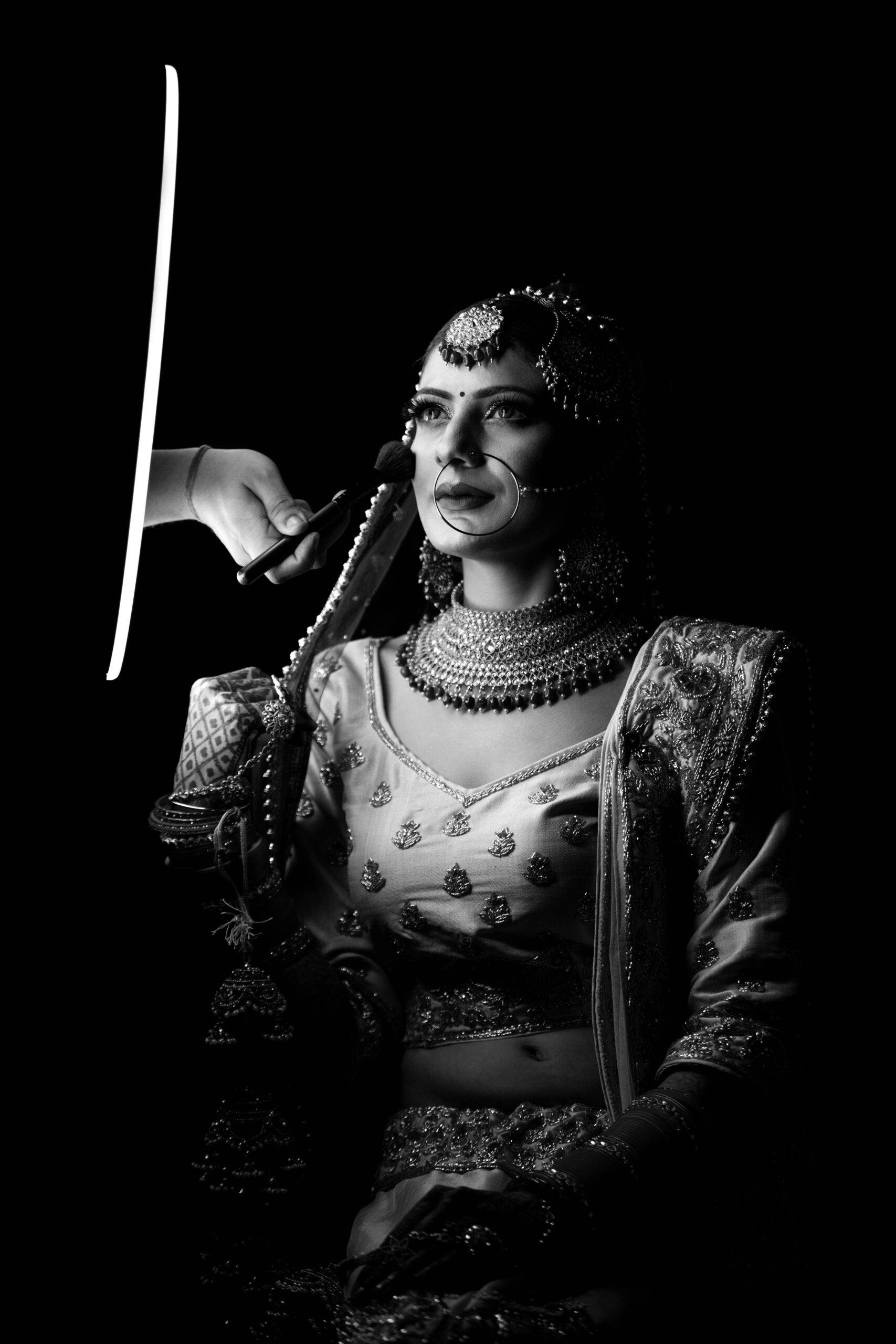 A stunning black and white portrait of an Indian bride in traditional attire, ready for her wedding.